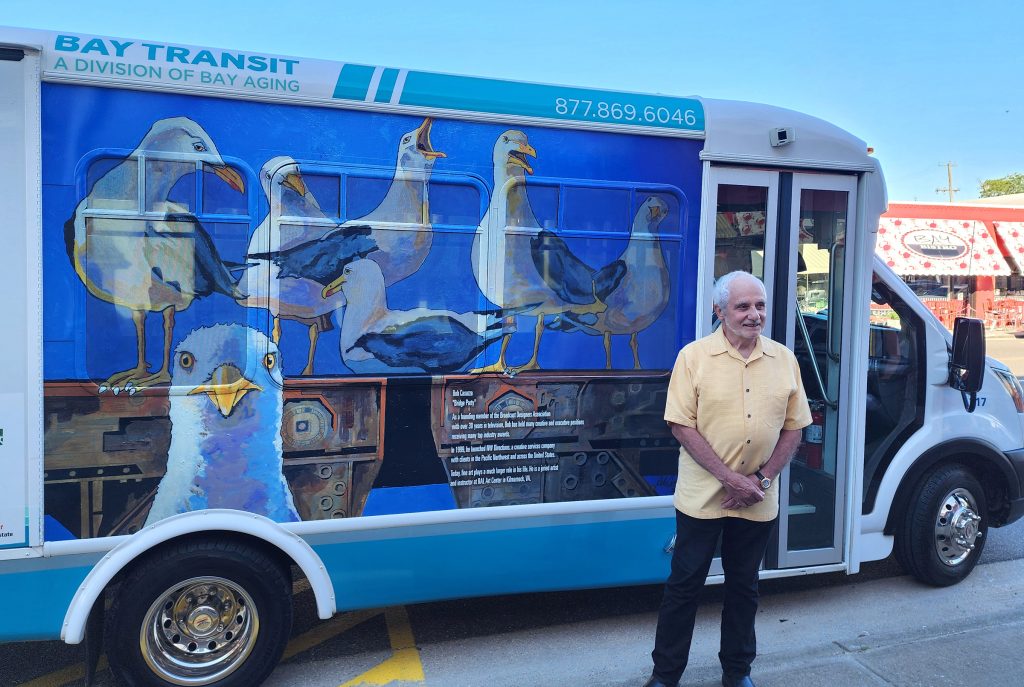 Man Standing in front of Bus